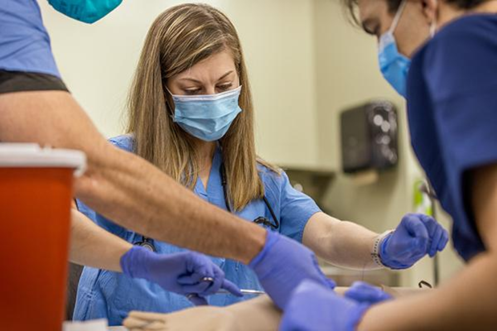 Polaris Dawn’s medical officer Anna Menon practices suturing an arm at McGovern Medical School's simulation lab during space medicine training. (Photo by UTHealth Houston)